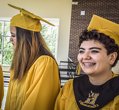 girl smiling in yello robe and hat