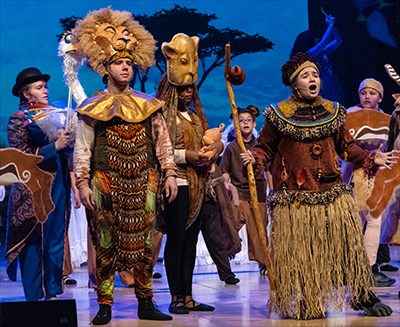 girl and boy on stage in lion king costumes