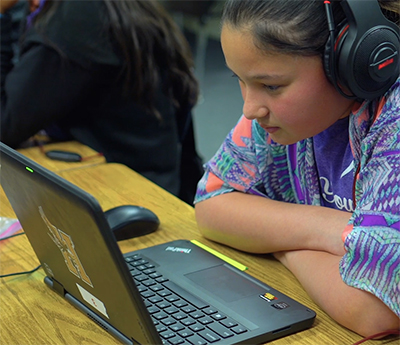 girl hunched over computer reading