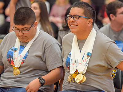 smiling boys with medals around their necks