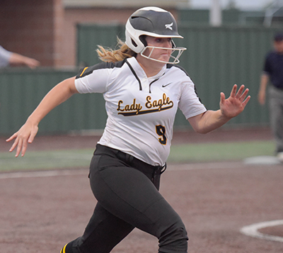 girl running to base in uniform