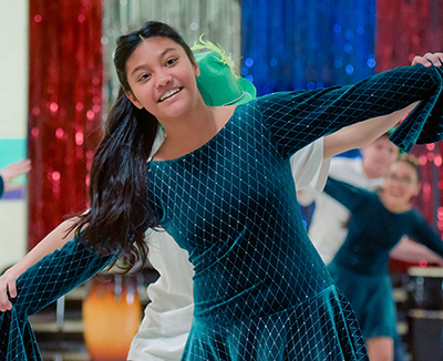 girl in Irish tap dress with hands outstretched