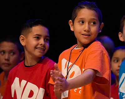 boy on stage smiling