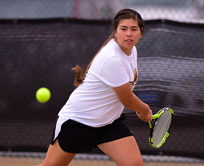 girl with eye on ball getting ready to make a return