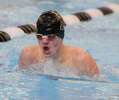 boy swimmer with head out of water doing breast stroke