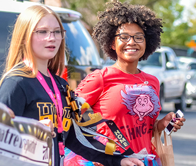 smiling girl walking in parade