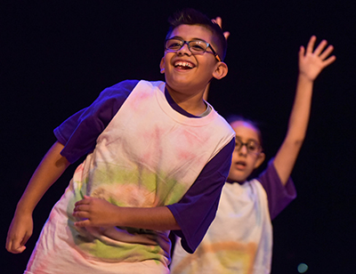 kid smiling on stage