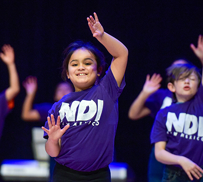 smiling girl dancing on stage