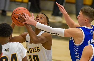 player battling through block with basketball