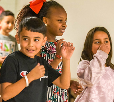 kids smiling on stage