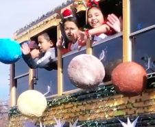 girls waving inside a bus