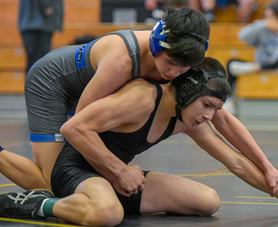 wrestler trying to get out of a hold