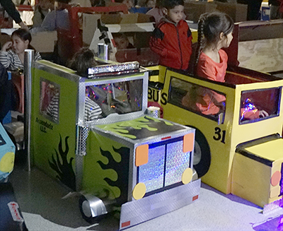 students in cars made out of cardboard boxes