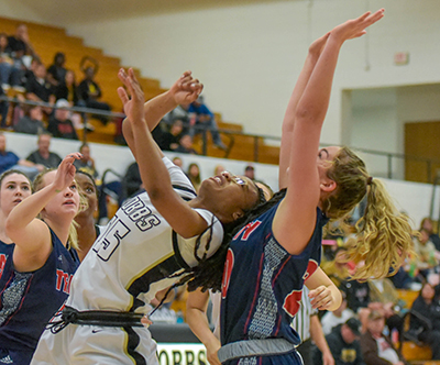 two girls going up for rebound