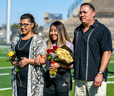 Girl standing with parents