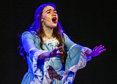 girl in costume singing