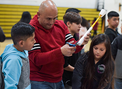 parent and children working on a project