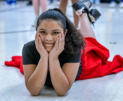 girl on ground with face in hands