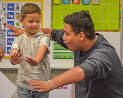 teenager give small boy acting lesson