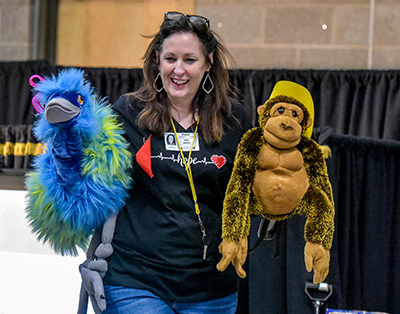 smiling lady with two puppets