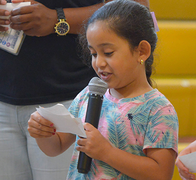 girl speaking into microphone