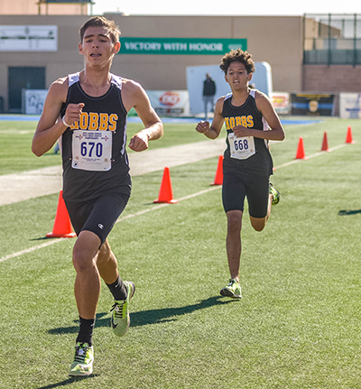 two runners about to cross finish line