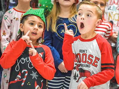 two students in first grade singing