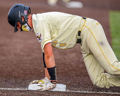 player on his hands and knees at third base