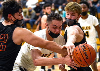 three players fighting for rebound