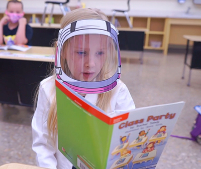 student in visor reading