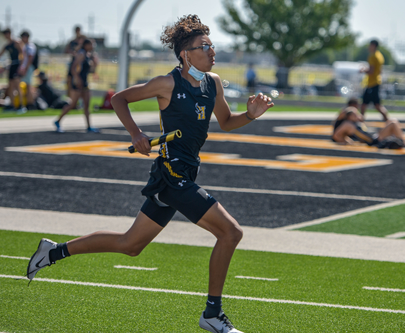 runner on track with baton