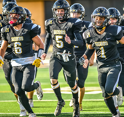 players running on field smiling