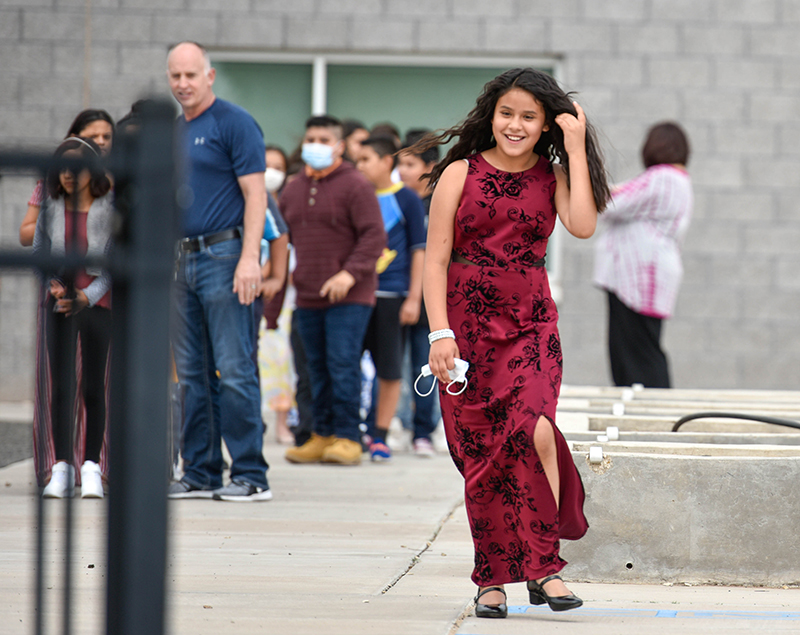 smiling girl in dress walking outside