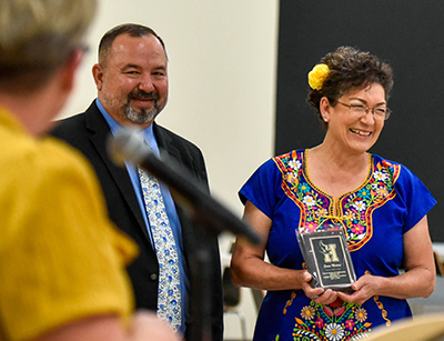 smiling woman with plaque