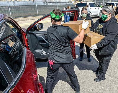 people loading boxes into cars