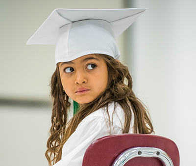 girl in cap looking backward