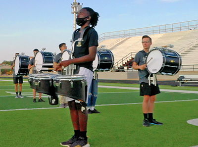 drummer standing on football field