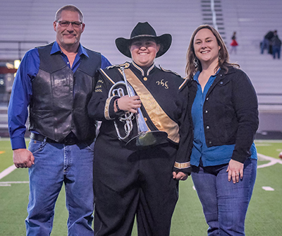 smiling parents with band member