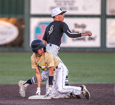 player crouching on second base looking behind him