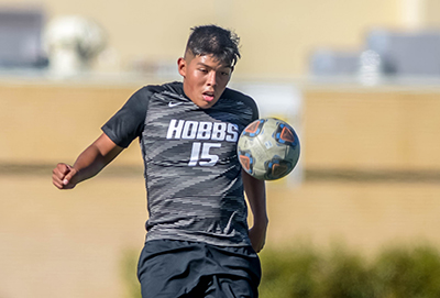 soccer player stopping ball with stomach