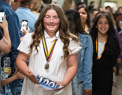 smiling student walking in hall