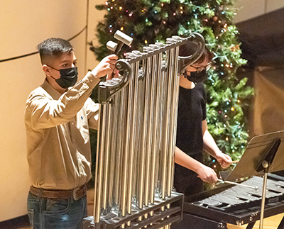 boy playing chimes