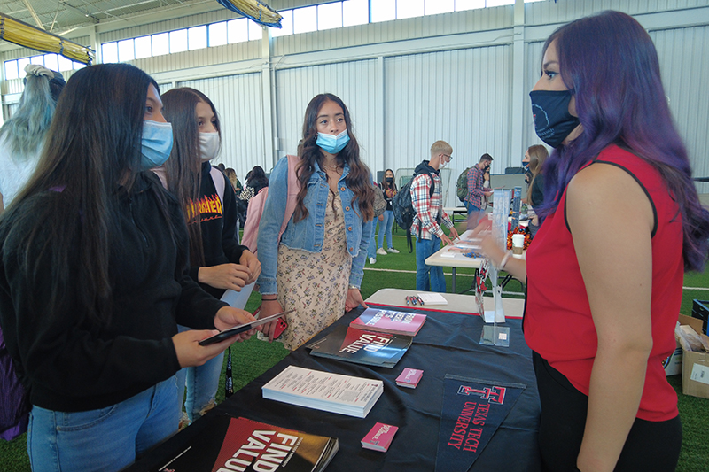 woman in masks standing and talking