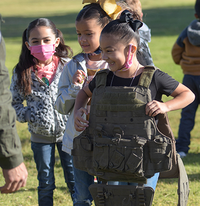 smiling girl with bullet vest