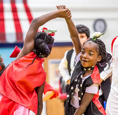 two girls dancing and smiling