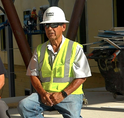 man in hardhat and vest on construction site