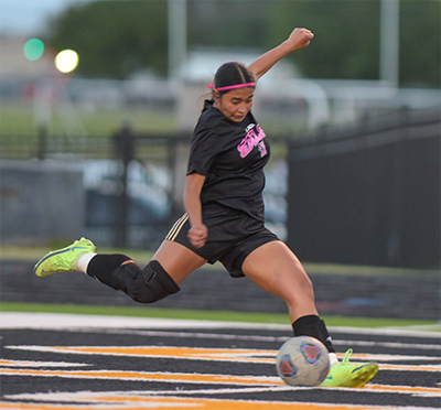 girl kicking ball