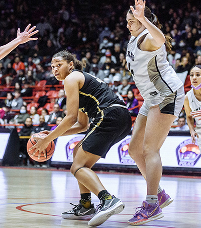 girl trying to dribble while being guarded