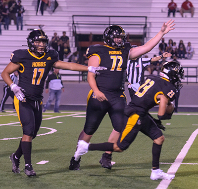 players with arms up after fumble recovery