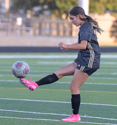 girl kicking ball